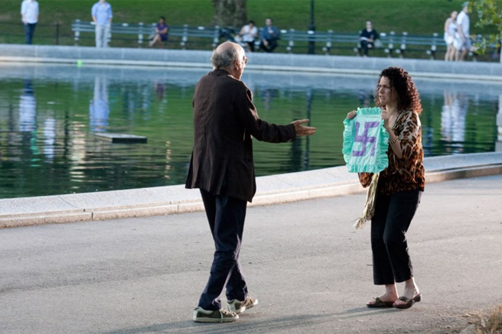 larry david in curb your enthusiasm trying to explain a swastika needlepoint to suzie